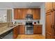 Kitchen with wood cabinets, granite countertops, and stainless steel appliances at 203 Stoney Dr, Durham, NC 27703