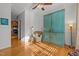 Living room with teal cabinet, comfortable armchair, hardwood floors at 203 Stoney Dr, Durham, NC 27703