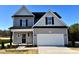 Two-story house with gray siding, black accents, and a two-car garage at 209 Danube Dr, Zebulon, NC 27597