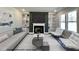 Virtually staged living room with a fireplace and built-in shelving at 209 Danube Dr, Zebulon, NC 27597