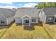 Aerial view showcases a well-maintained lawn and backyard with a covered patio on a gray home at 209 Meadowbark Bnd # 20, Garner, NC 27529