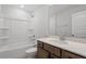 Bright bathroom with a shower-tub combo, vanity with solid surface countertops, and a decorative framed mirror at 209 Meadowbark Bnd # 20, Garner, NC 27529