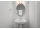 Simple powder room featuring a pedestal sink, oval mirror, and a bright, clean aesthetic at 209 Meadowbark Bnd # 20, Garner, NC 27529