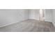 Carpeted bedroom with two white doors and an open doorway to another room at 209 Meadowbark Bnd # 20, Garner, NC 27529
