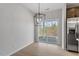 Light-filled dining area with hardwood floors, modern chandelier, and large sliding glass doors to the backyard at 209 Meadowbark Bnd # 20, Garner, NC 27529