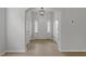 Bright entryway with wood flooring, white walls, modern light fixture and lots of natural light at 209 Meadowbark Bnd # 20, Garner, NC 27529