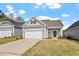 Charming single-story home featuring a two-car garage, gray siding, and a well-manicured lawn under a bright blue sky at 209 Meadowbark Bnd # 20, Garner, NC 27529