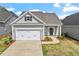 Beautiful home with gray siding, two-car garage, and manicured lawn, offering a welcoming curb appeal at 209 Meadowbark Bnd # 20, Garner, NC 27529