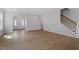 Open-concept living space with beautiful wood floors, staircase, and lots of natural light at 209 Meadowbark Bnd # 20, Garner, NC 27529