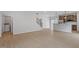 Spacious open-concept area with wood floors, staircase and the kitchen in the background at 209 Meadowbark Bnd # 20, Garner, NC 27529