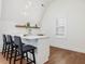 Modern wet bar with white cabinetry and quartz countertop at 24 Barn Owl Ln, Pittsboro, NC 27312