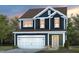 Two-story house with a white garage door and dark blue siding at 2908 Huxley Way, Apex, NC 27502