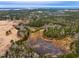 Aerial view of a property with a pond and forest at 330 Ellis Stewart Ln Ln, Cameron, NC 28326