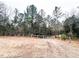 Wooded lot entrance with gate and long driveway at 330 Ellis Stewart Ln Ln, Cameron, NC 28326