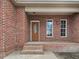 Brick front porch with a wooden door and windows at 330 Ellis Stewart Ln Ln, Cameron, NC 28326