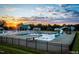 Community pool area at sunset with swimming pools, slides, and lounge chairs at 346 Maidenhair Pl, Clayton, NC 27520