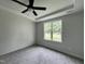 Light-filled bedroom with a large window and neutral carpet, providing a serene and comfortable atmosphere at 356 Maidenhair Pl, Clayton, NC 27520