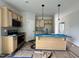 A kitchen featuring light wood cabinets, stainless steel appliances, and a central island with pendant lighting at 356 Maidenhair Pl, Clayton, NC 27520