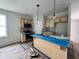 Bright kitchen boasts light wood cabinets, stainless steel appliances, and a functional island with sink and pendant lighting at 356 Maidenhair Pl, Clayton, NC 27520