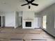 Open living room with a ceiling fan, fireplace with a wood mantle, and built-in shelving provides an inviting space at 356 Maidenhair Pl, Clayton, NC 27520