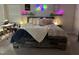 Inviting bedroom with a rustic wooden bed frame, soft bedding, and ambient lighting, offering a peaceful retreat at 359 Ballast Pt, Clayton, NC 27520