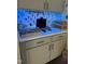 Modern counter space, featuring a sleek laptop, decorative baskets, and a stylish backsplash with subtle blue lighting at 359 Ballast Pt, Clayton, NC 27520