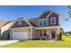 Charming two-story home features a manicured lawn and attached two-car garage at 359 Ballast Pt, Clayton, NC 27520