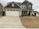 Charming two-story home featuring a spacious driveway and well-manicured front yard at 359 Ballast Pt, Clayton, NC 27520