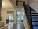 Bright foyer with dark wood flooring, modern staircase, and an open view of the home at 359 Ballast Pt, Clayton, NC 27520
