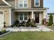 A welcoming front porch with stylish decor creates an inviting outdoor seating area at 359 Ballast Pt, Clayton, NC 27520