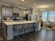 Modern kitchen with gray cabinets, quartz countertops, and stainless steel appliances at 359 Ballast Pt, Clayton, NC 27520