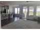 Open-concept living space featuring dark hardwood floors, modern furniture, and lots of natural light at 359 Ballast Pt, Clayton, NC 27520
