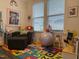 Bright playroom with colorful floor mat, comfortable seating, and playful decorations, perfect for activities at 359 Ballast Pt, Clayton, NC 27520