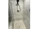 Modern shower with sleek white tile and contemporary fixtures, offering a clean and refreshing space for daily use at 359 Ballast Pt, Clayton, NC 27520