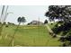 View of a golf course with a lush green fairway and a well-maintained putting green at 382 Maidenhair Pl, Clayton, NC 27520