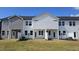 Townhome backyards featuring a lawn with natural grass, white privacy fences, and neutral siding at 3854 Well Fleet Drive, Fuquay Varina, NC 27526