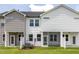 Townhome backyard with green grass, partial privacy fence and screened-in patio at 3854 Well Fleet Drive, Fuquay Varina, NC 27526