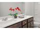 Bathroom featuring a double vanity with dark wood cabinets, white countertop, and floral arrangement at 3854 Well Fleet Drive, Fuquay Varina, NC 27526