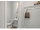 Stylish half bathroom features a pedestal sink, decorative mirror, and convenient coat hooks at 3854 Well Fleet Drive, Fuquay Varina, NC 27526