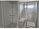 Tiled walk-in shower with glass doors and a built-in bench creates a spa-like experience at 3854 Well Fleet Drive, Fuquay Varina, NC 27526