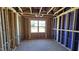 Unfinished bedroom featuring exposed beams, framing and a window allowing natural light at 3854 Well Fleet Drive, Fuquay Varina, NC 27526