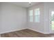 Bright bedroom showcasing hardwood floors, a door to outdoor space, and plenty of natural light at 3854 Well Fleet Drive, Fuquay Varina, NC 27526