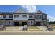 New townhomes featuring modern design with a 1-car garage and attractive curb appeal on a sunny day at 3854 Well Fleet Drive, Fuquay Varina, NC 27526