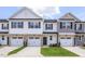 Charming townhome featuring a stone-accented facade, white siding, and well-manicured front lawn at 3854 Well Fleet Drive, Fuquay Varina, NC 27526