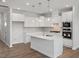 Modern kitchen featuring stainless steel appliances, white cabinetry, and a center island at 3854 Well Fleet Drive, Fuquay Varina, NC 27526