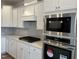 Close up of modern kitchen featuring white cabinetry, quartz counters, stainless steel appliances, and gas range at 3854 Well Fleet Drive, Fuquay Varina, NC 27526