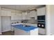 Modern kitchen featuring white cabinetry, stainless steel appliances, and a center island with sink at 3854 Well Fleet Drive, Fuquay Varina, NC 27526