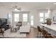 Bright living room with multiple windows, ceiling fan and a cozy sofa with stylish accents at 3854 Well Fleet Drive, Fuquay Varina, NC 27526