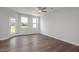 Spacious living room features hardwood floors, a ceiling fan, and a door to outdoor space at 3854 Well Fleet Drive, Fuquay Varina, NC 27526