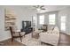 Spacious living room with comfortable seating, media center, and ample natural light from large windows at 3854 Well Fleet Drive, Fuquay Varina, NC 27526